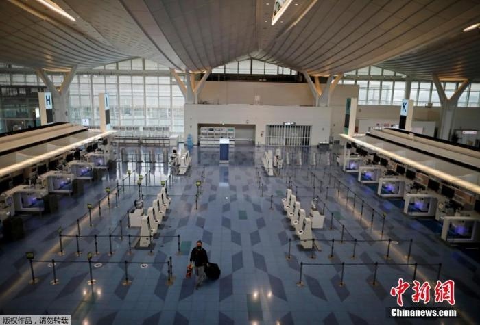 資料圖：日本東京，東京國際機場，一名乘客在國際航班航站樓的登機區(qū)。