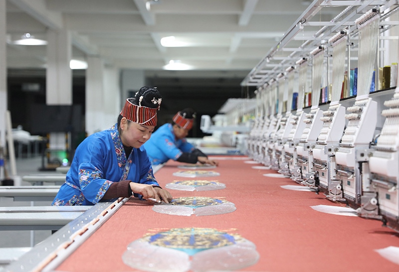 2023年2月13日，貴州省黔東南苗族侗族自治州施秉縣工業(yè)園區(qū)，工人在機(jī)繡車間作業(yè)。