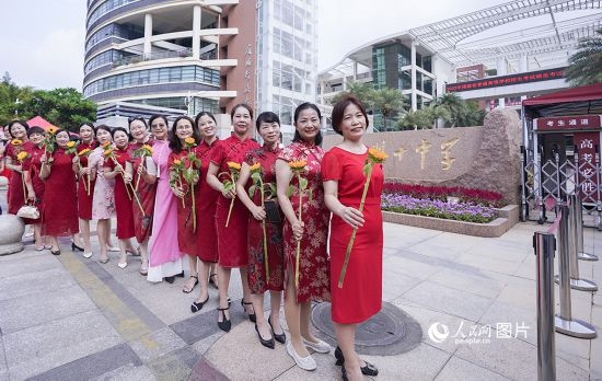 6月7日一早，廈門雙十中學考生家長們身穿旗袍，手拿向日葵在考場外為孩子加油打氣，寓意“旗開得勝，一舉奪魁”。人民網(wǎng)記者 陳博攝
