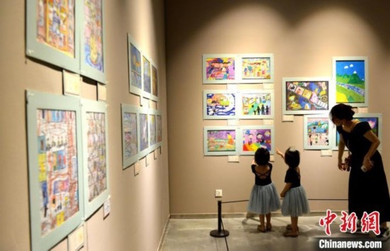 圖為家長帶著孩子參觀展覽。呂明 攝