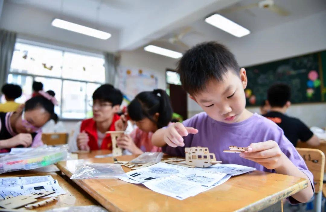 △今年7月，在浙江余姚市舜北小學(xué)暑托班內(nèi)，孩子們制作太陽能科學(xué)實(shí)驗(yàn)裝置。