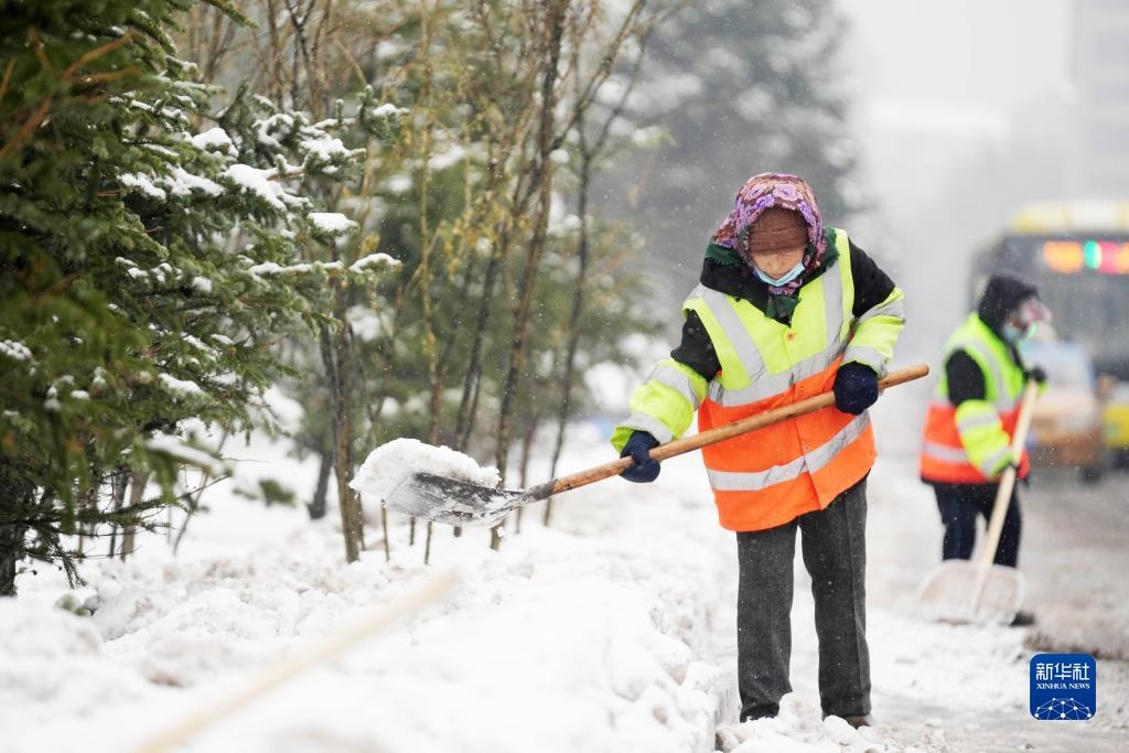 11月16日，環(huán)衛(wèi)工人在清理道路上的積雪。當(dāng)日，黑龍江哈爾濱市迎來雨雪天氣。新華社記者 王建威 攝